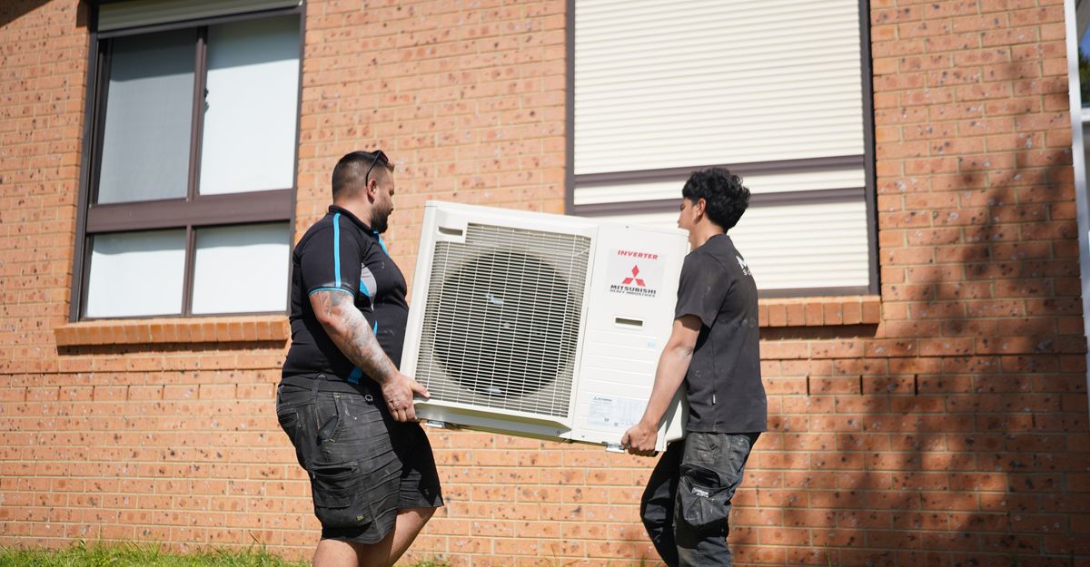 Mist Air technicians carrying a unit
